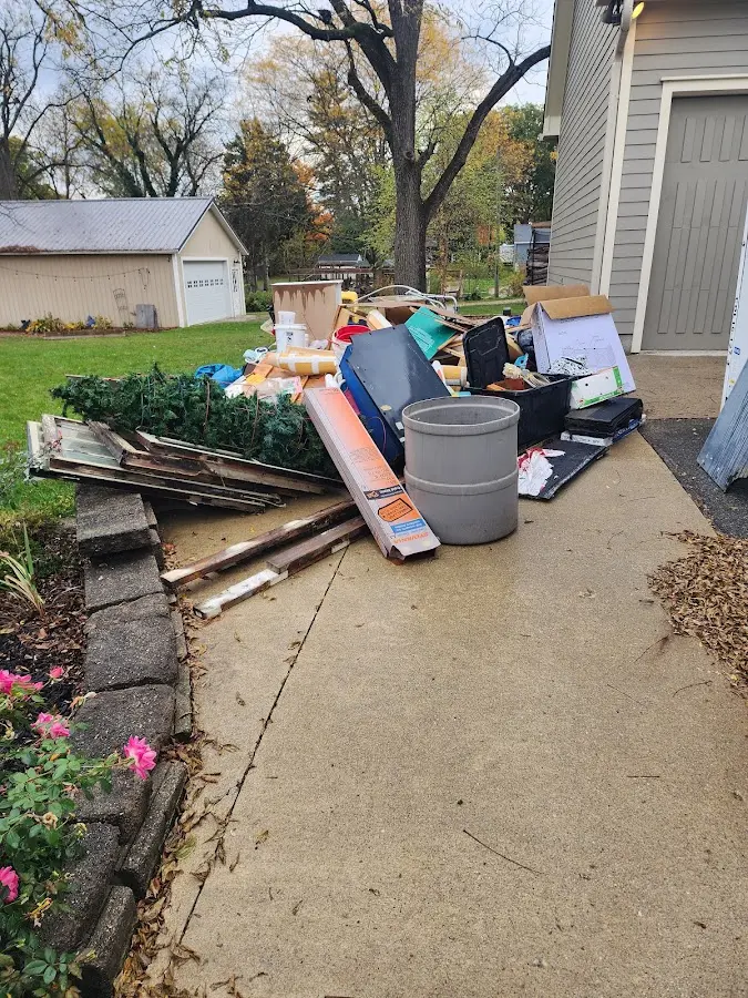 Dumpster being loaded with debris for 12 Yard Dumpster Rental in McGregor